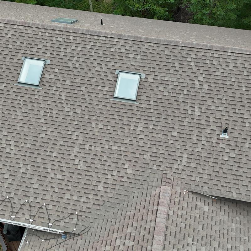 Asphalt shingle roof with skylights and vent pipes