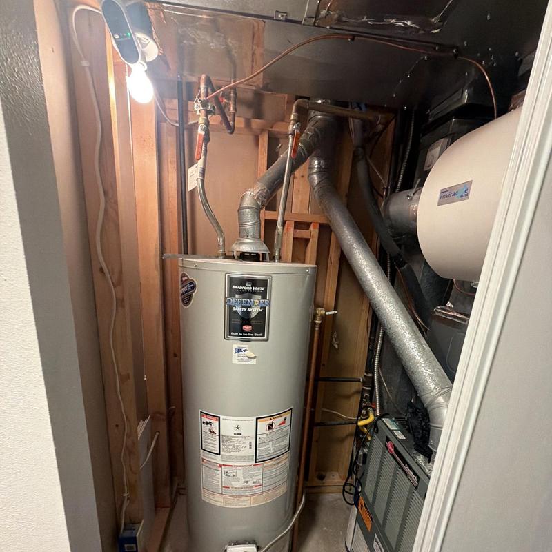 Water heater installation with venting and plumbing connections Water heater installation with venting and plumbing connections