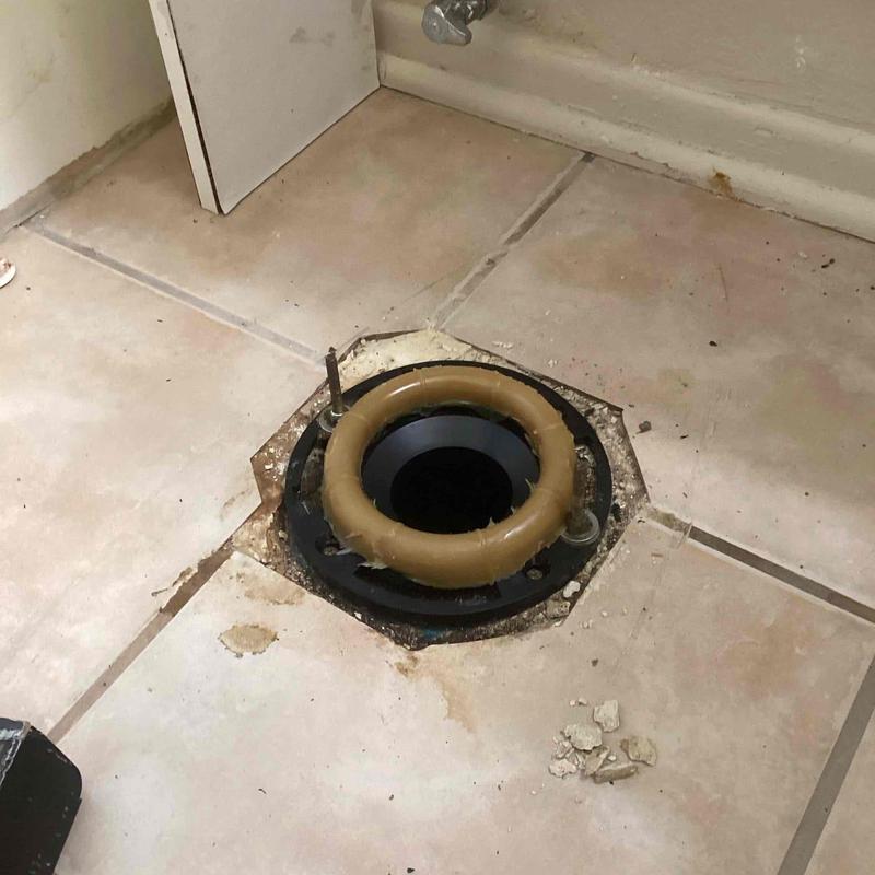 Toilet flange on tiled floor with sealant removed