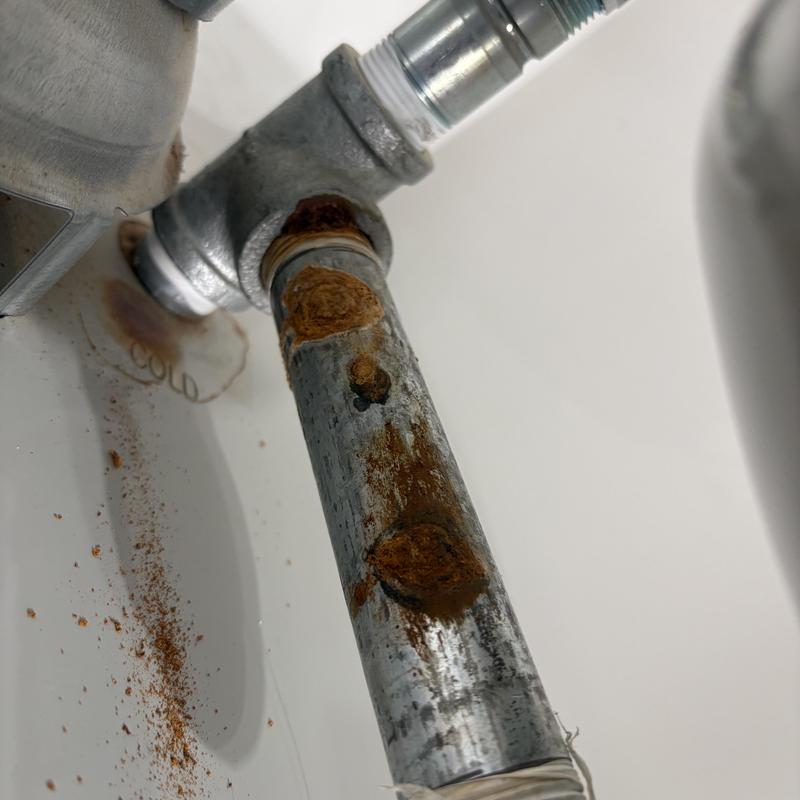 Rusty galvanized water pipe connection with fitting Rusty galvanized water pipe connection with fitting