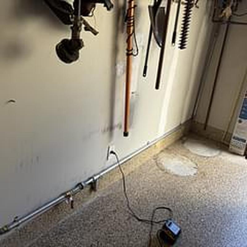 Gas line installation along garage wall with shutoff valve