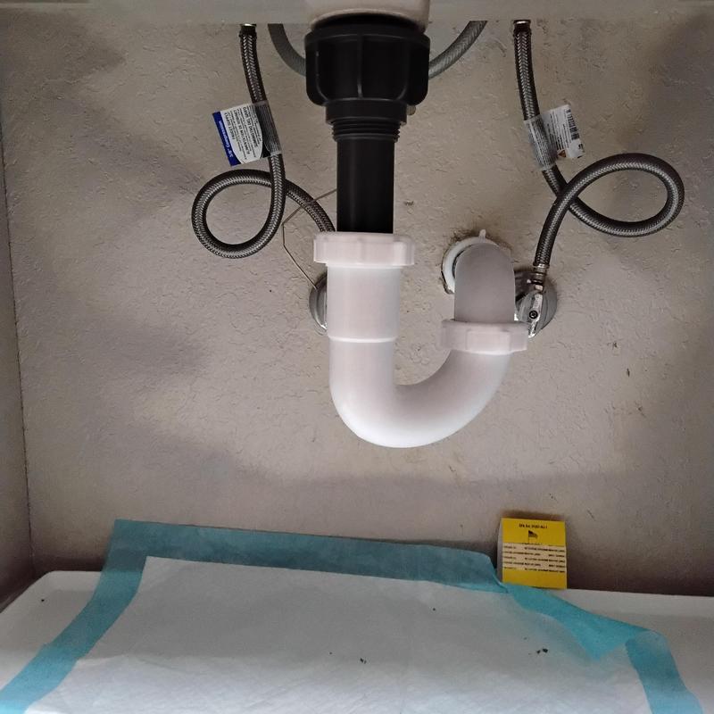 Silver push pop drain assembly under sink with supply lines