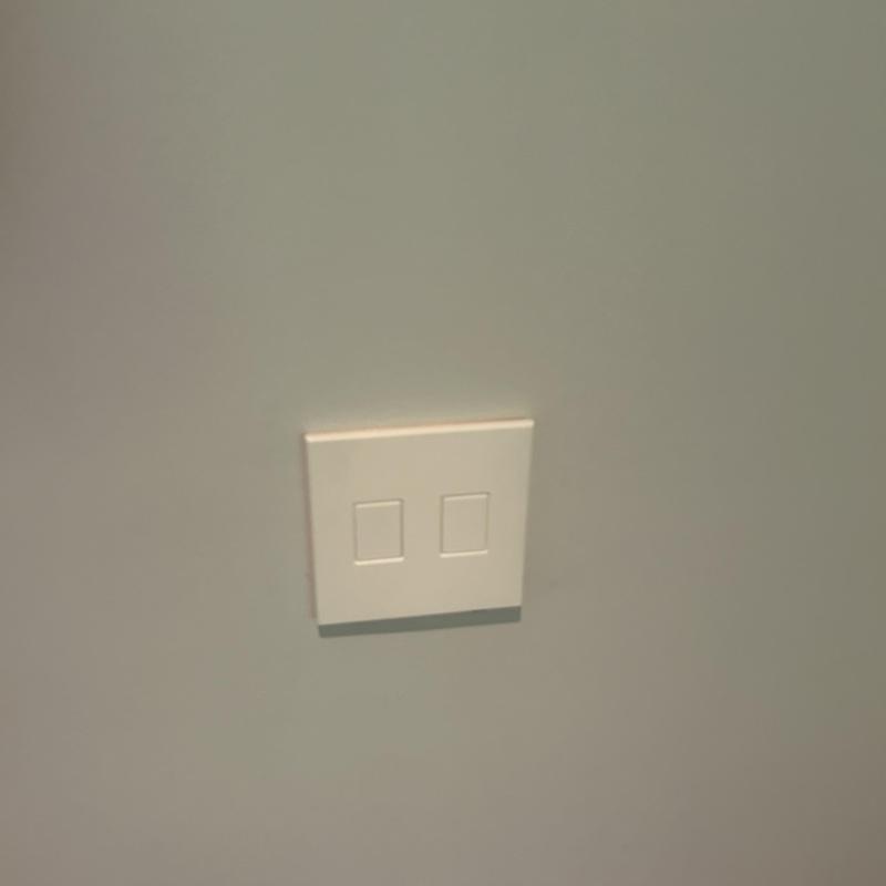 Smart light switches with temporary replacement plate on wall
