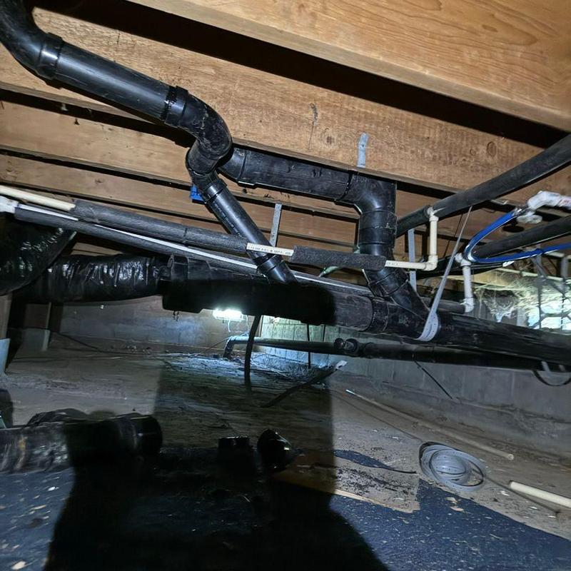 ABS waste piping and venting system under floor joists
