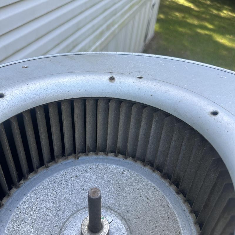 Air conditioner blower wheel with dust buildup cleaning needed