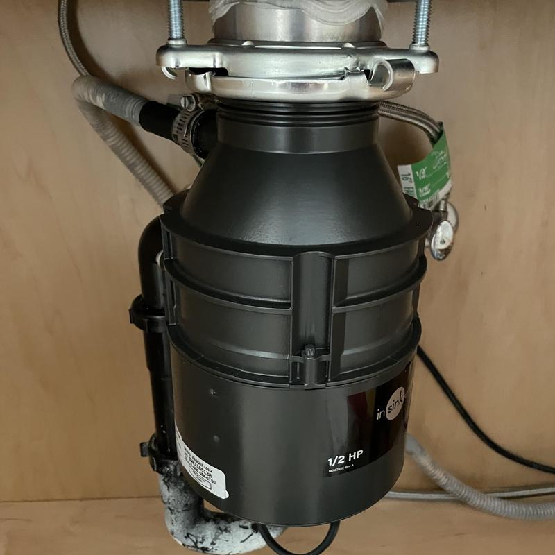 Garbage disposal unit under kitchen sink installation