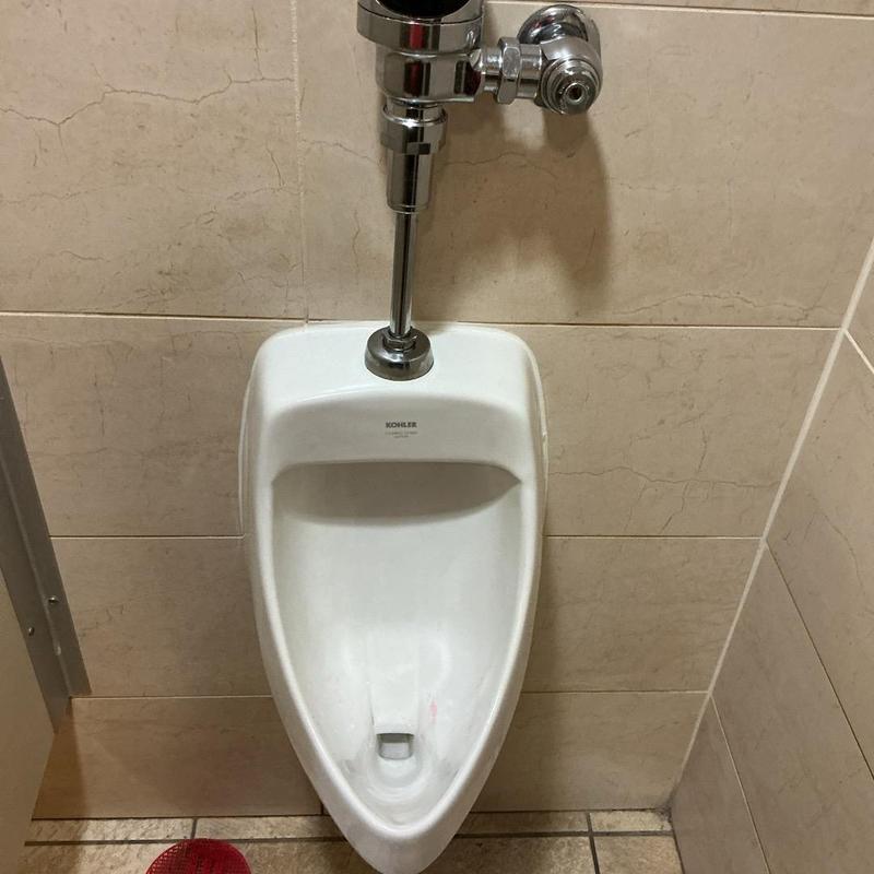 Urinal flush valve and fixture with wall tiles Urinal flush valve and fixture with wall tiles