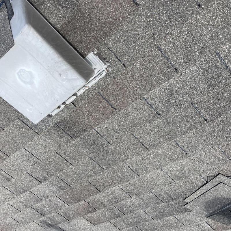 Roof flashing and shingle installation on residential roof