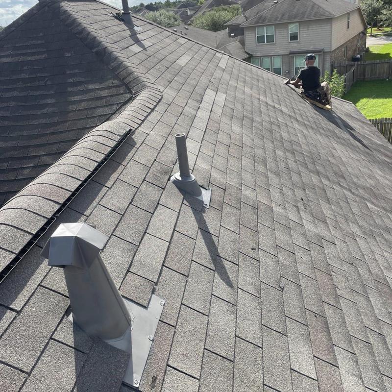 Roof shingles and flashing with vent pipe installation