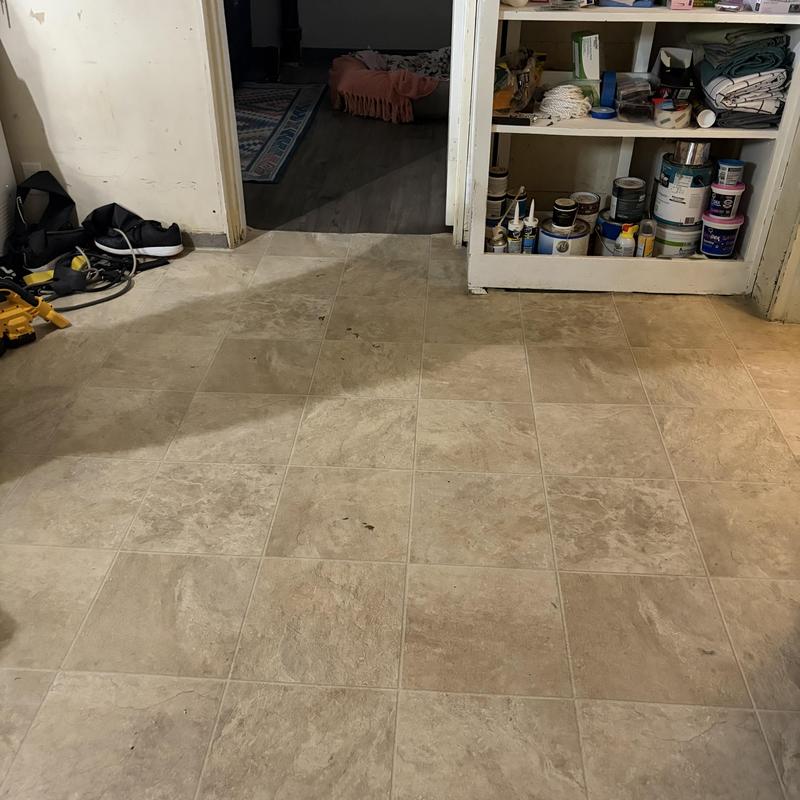 Basement floor tile installation prep with shelving unit Basement floor tile installation prep with shelving unit