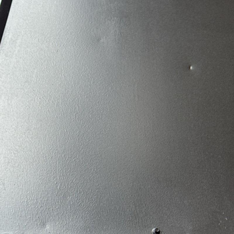Apartment roofing system with hail damage dent