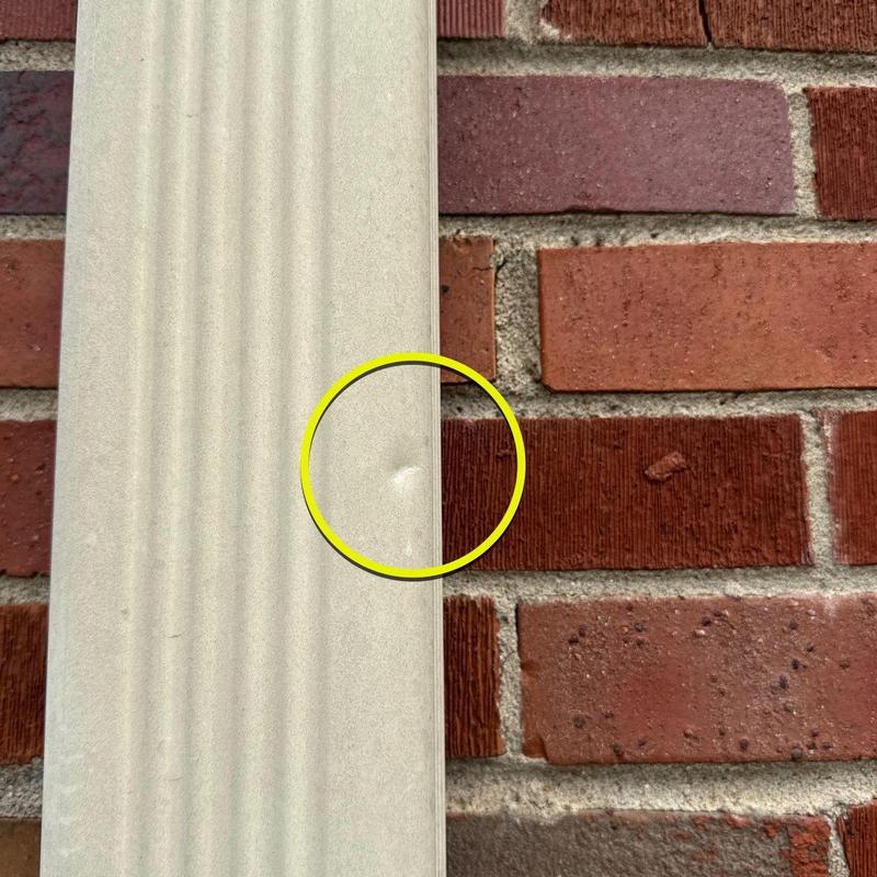 Vinyl siding dent with yellow inspection circle