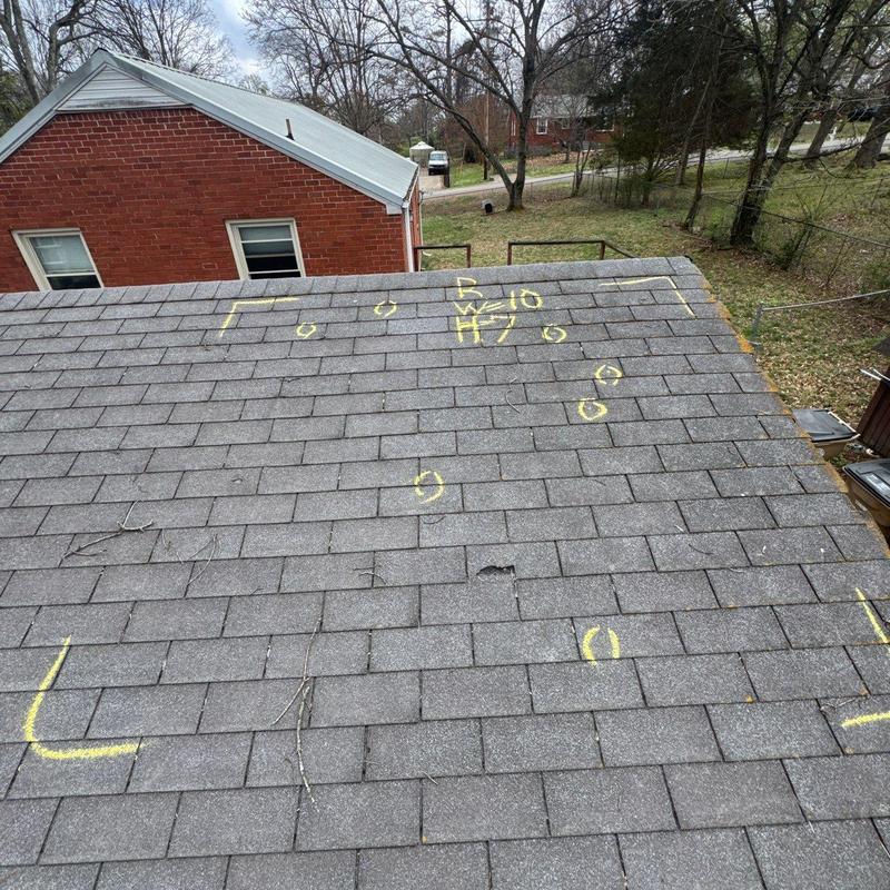 Asphalt shingles with marked hail damage on roof