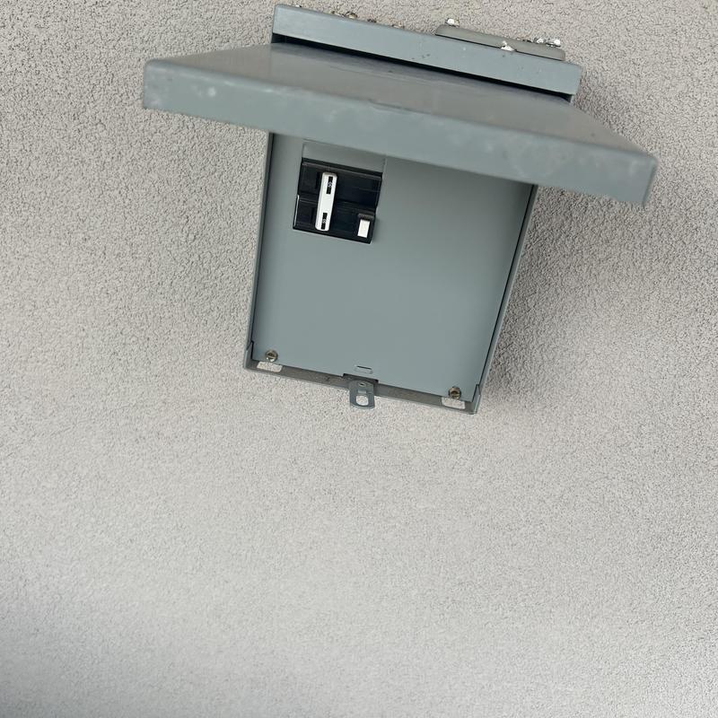 Electrical breaker panel with open cover on wall Electrical breaker panel with open cover on wall