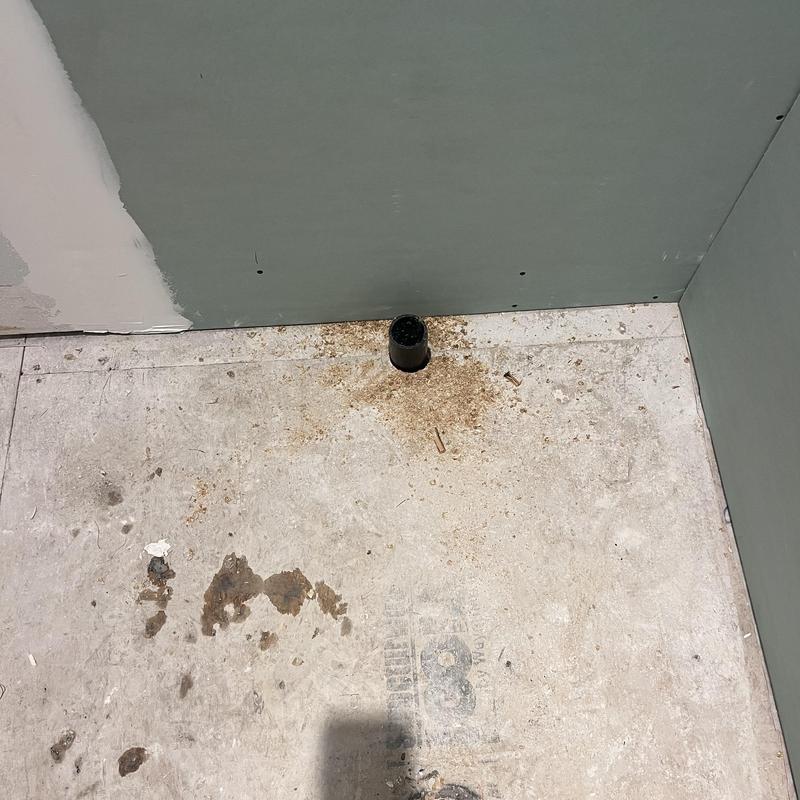 Shower drain pipe in bathroom floor corner installation