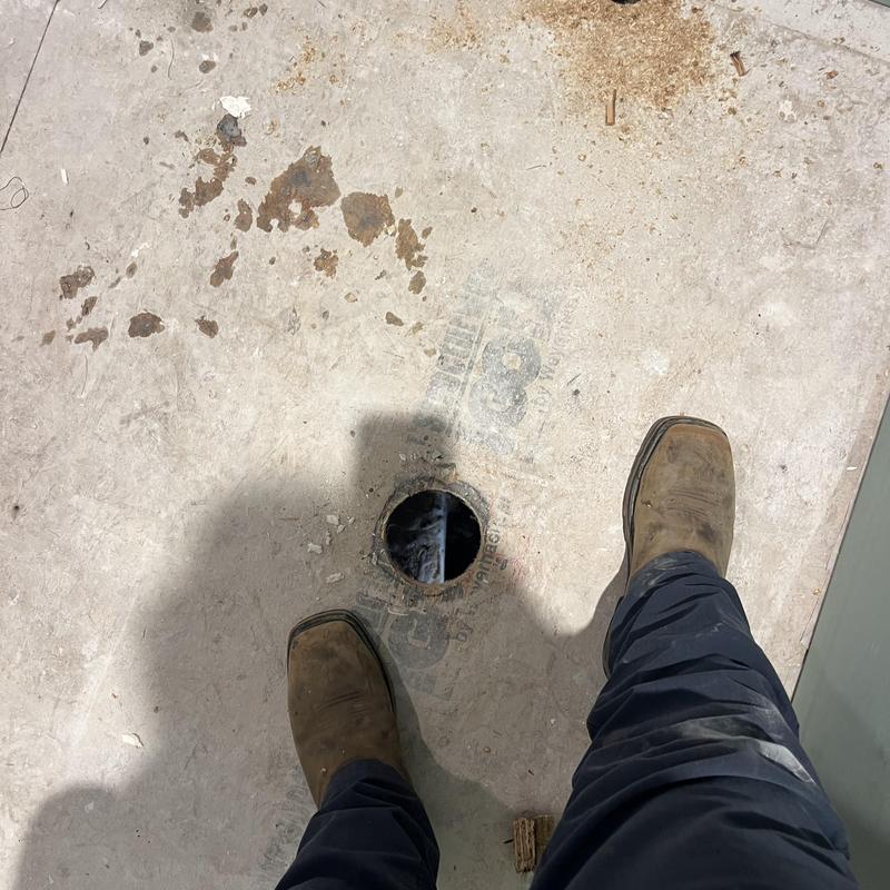 Shower drain relocation with exposed floor hole