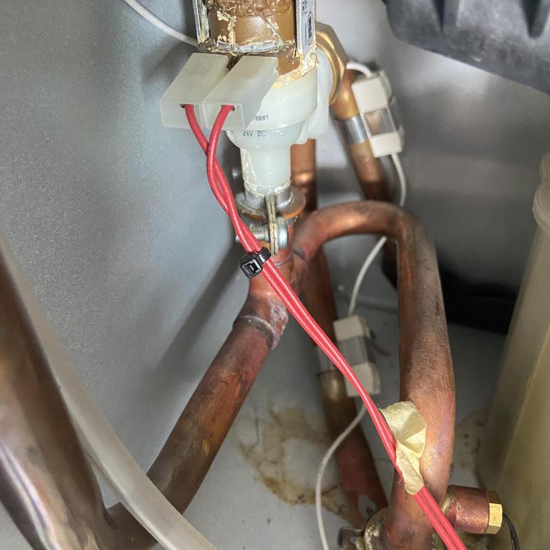 Tankless water heater wiring and copper piping close-up Tankless water heater wiring and copper piping close-up