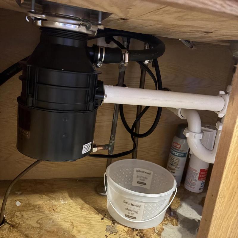 Garbage disposal and plumbing under kitchen sink Garbage disposal and plumbing under kitchen sink