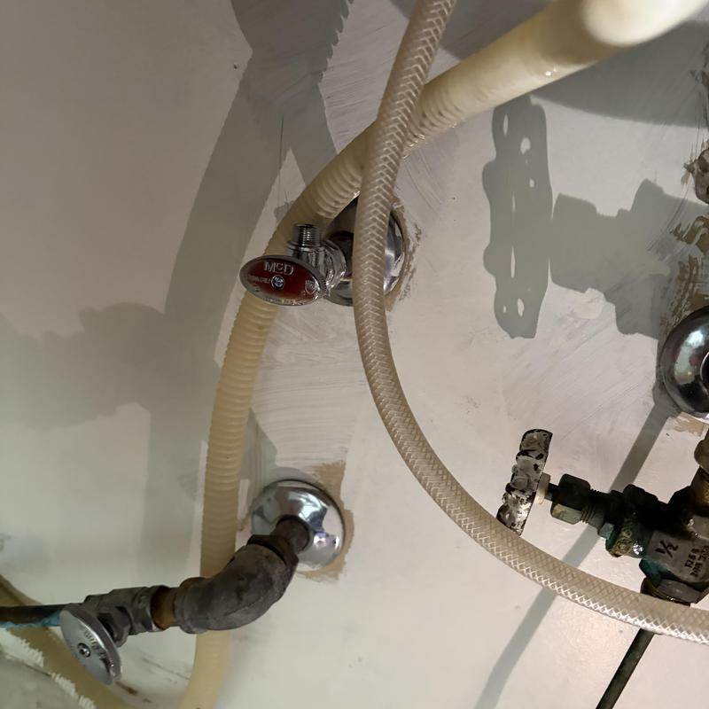 Emergency shut off valves under kitchen sink with hoses Emergency shut off valves under kitchen sink with hoses