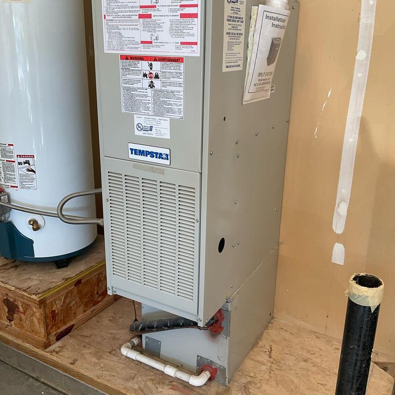 Furnace unit in utility room with piping Furnace unit in utility room with piping