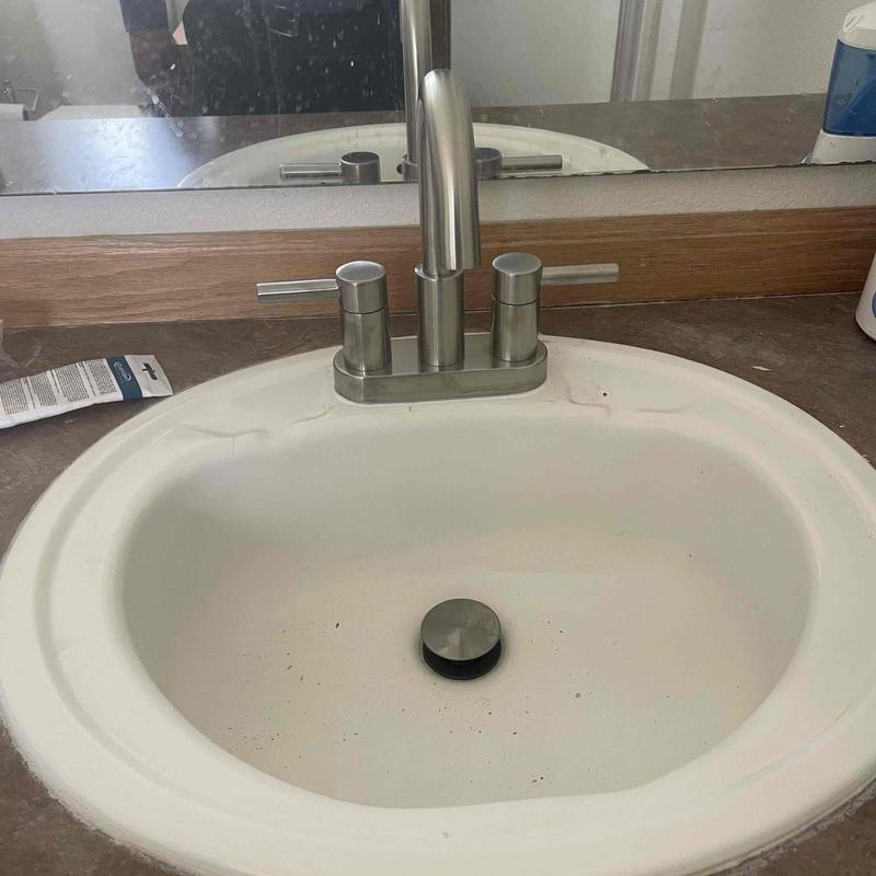 Bathroom lavatory faucet installation on sink basin