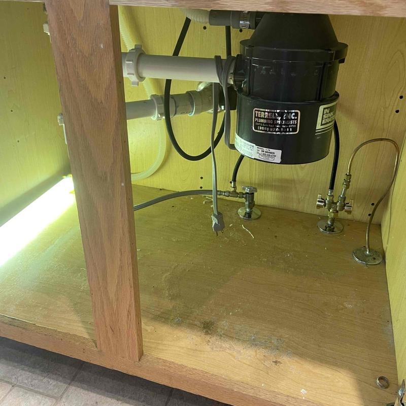 Garbage disposal and plumbing under kitchen sink installation