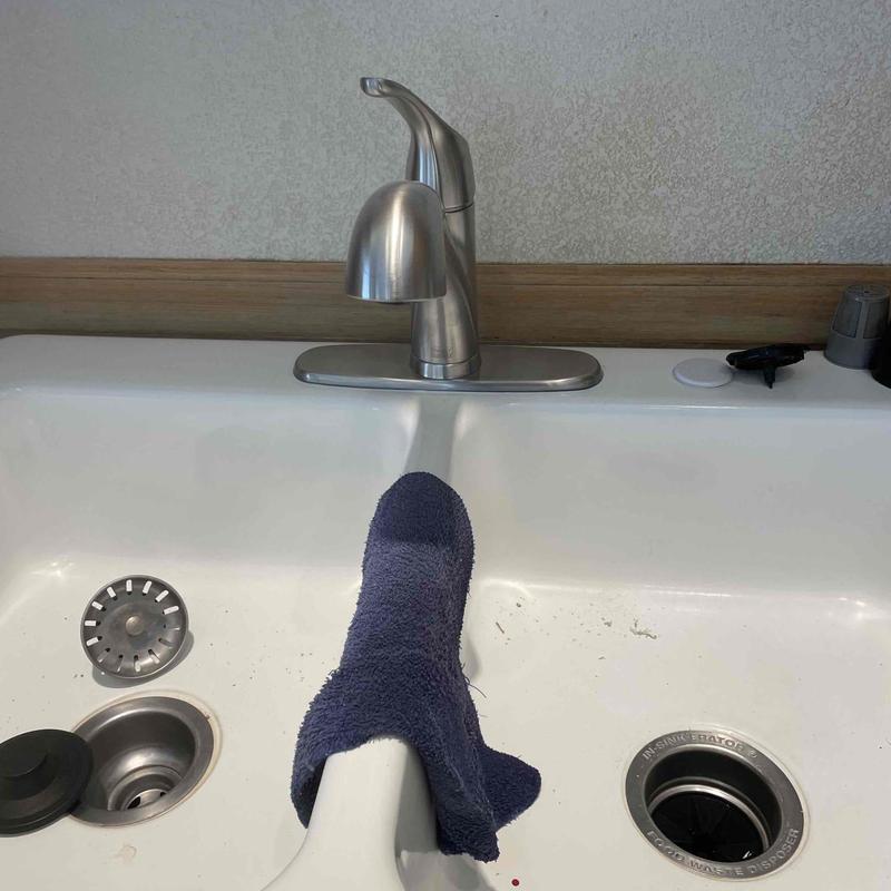 Bathroom lavatory faucet with towel on sink divider