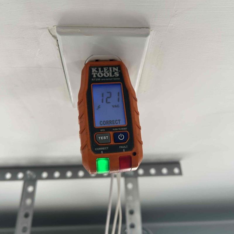 Outlet tester on ceiling receptacle showing correct wiring
