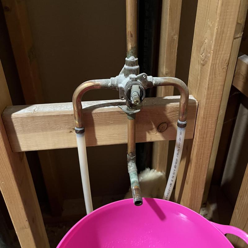 Shower valve and tub spout plumbing with capped spout