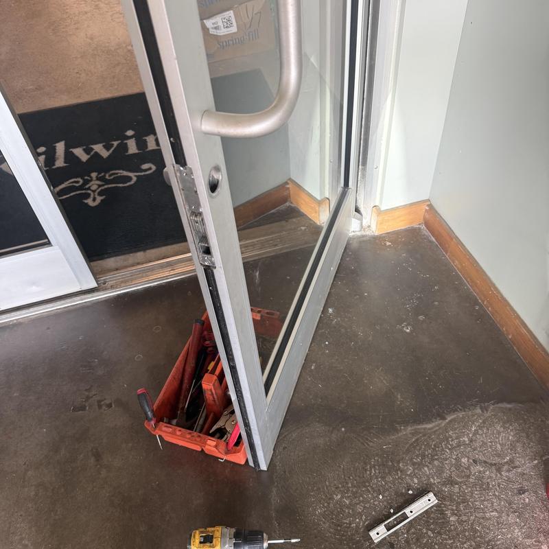 Glass door lock with locksmith tools on floor Glass door lock with locksmith tools on floor