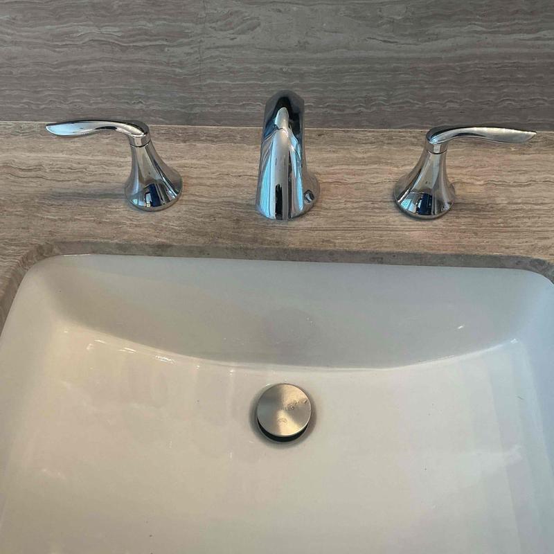 Pop-up drain assembly in bathroom sink with faucet