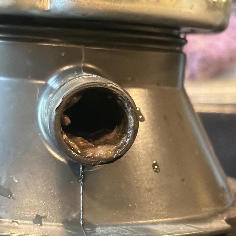 Garbage disposal clogged with food buildup inside drain tube Garbage disposal clogged with food buildup inside drain tube