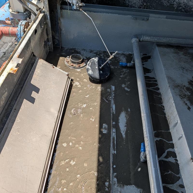Cooling tower water basin with float valve mechanism Cooling tower water basin with float valve mechanism