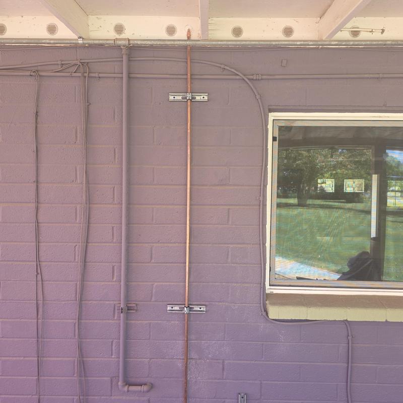 Copper hot water line surface mounted on exterior wall Copper hot water line surface mounted on exterior wall