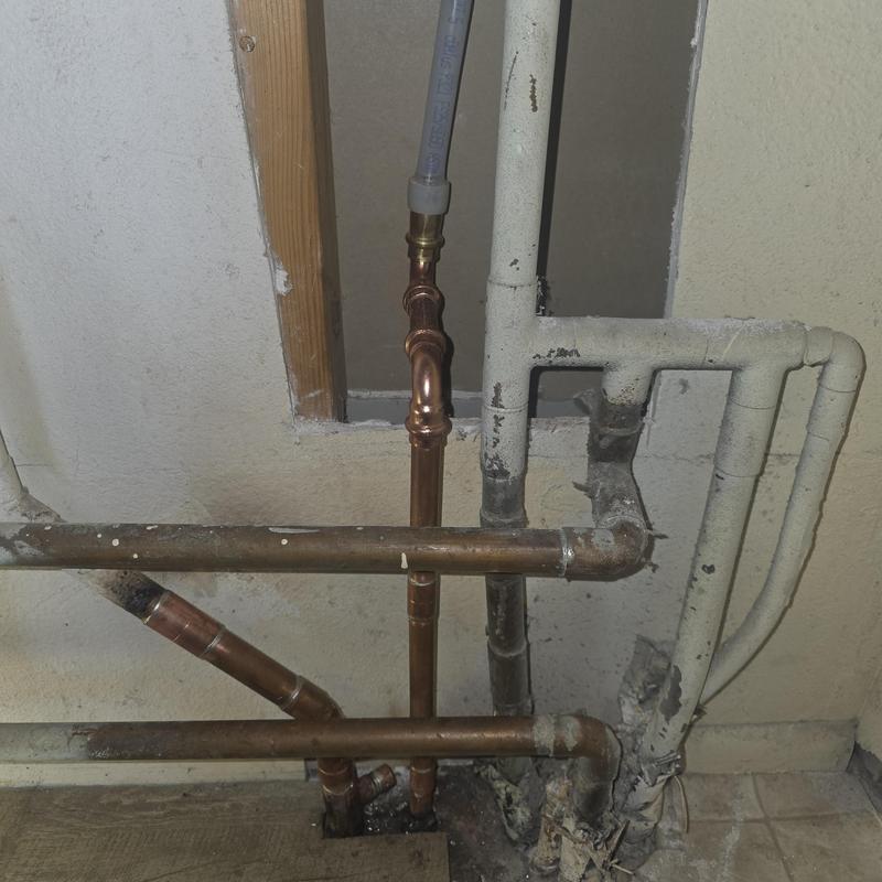 Copper hot water line reroute overhead on block wall Copper hot water line reroute overhead on block wall
