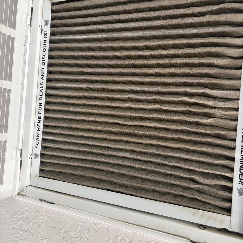 HVAC air filter clogged with dust buildup HVAC air filter clogged with dust buildup
