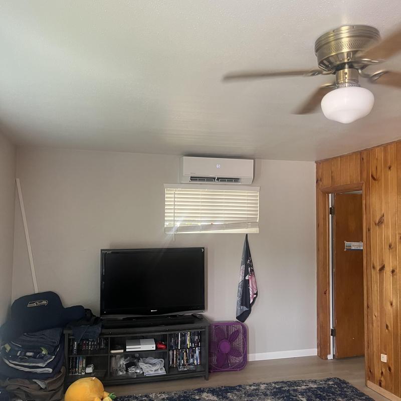 Mini split heat pump unit above window in living room Mini split heat pump unit above window in living room