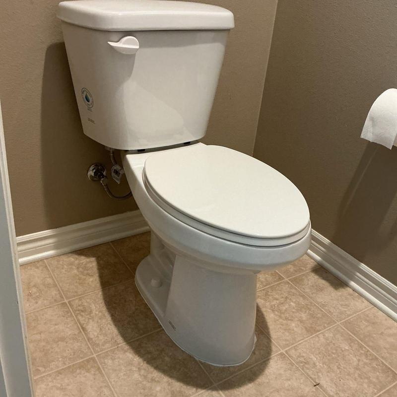 Western two-piece elongated toilet installed in bathroom
