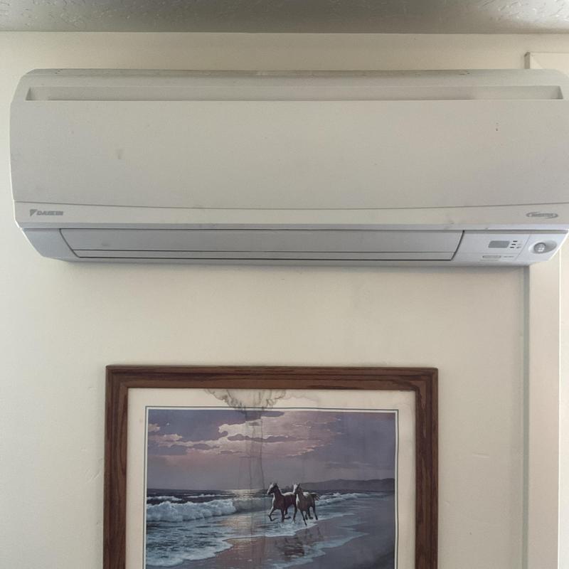 Mini split air conditioner mounted above wall art Mini split air conditioner mounted above wall art