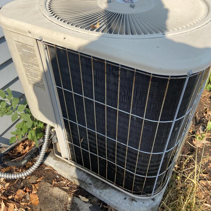 Air conditioner condenser unit with debris and dirt buildup Air conditioner condenser unit with debris and dirt buildup