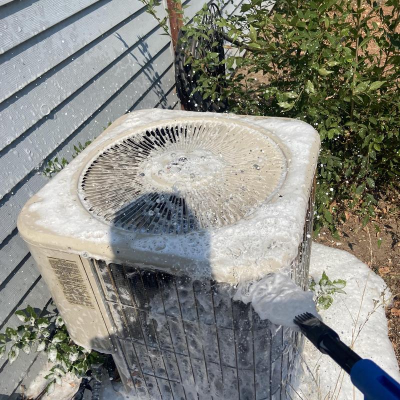 Air conditioner condenser cleaning with foam brush outside Air conditioner condenser cleaning with foam brush outside