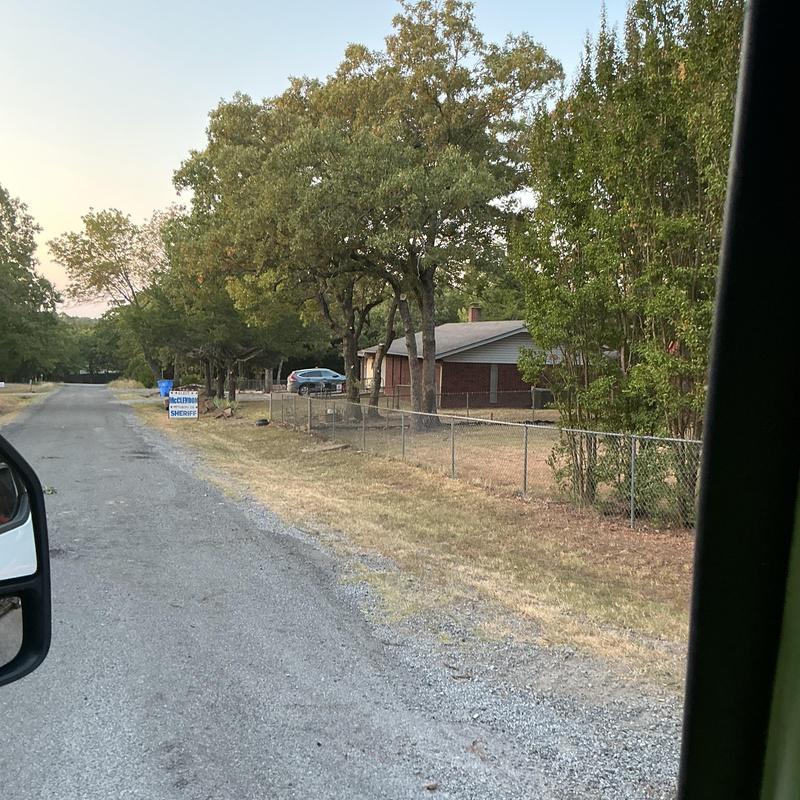 Residential chain-link fence along rural gravel road