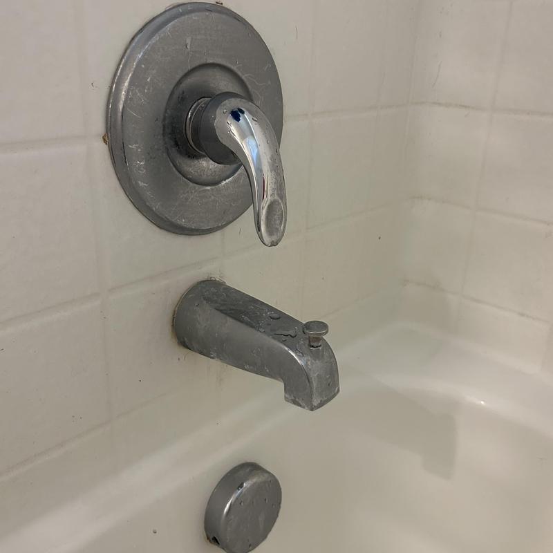 Tub spout and faucet handle in bathroom tub Tub spout and faucet handle in bathroom tub