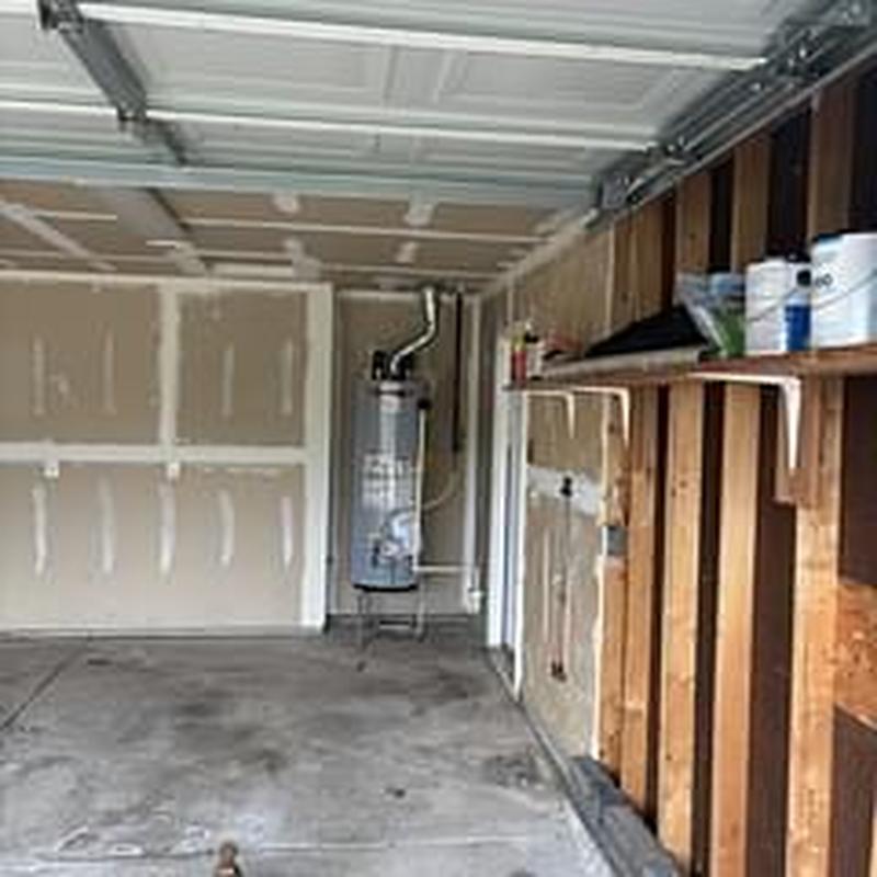 Water heater plumbing inspection in garage space