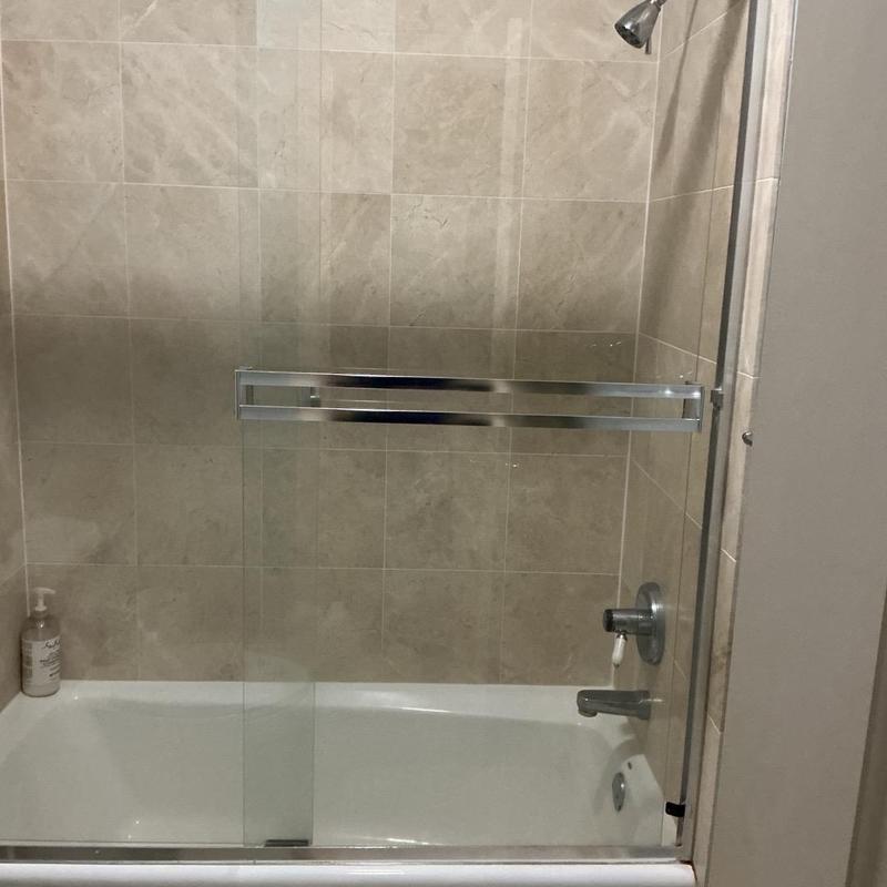 Tile shower enclosure with glass door and fixtures Tile shower enclosure with glass door and fixtures