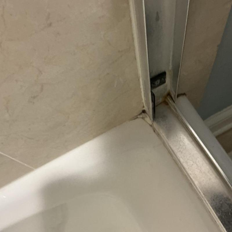 Tile floor corner cracks with water seepage near shower door Tile floor corner cracks with water seepage near shower door
