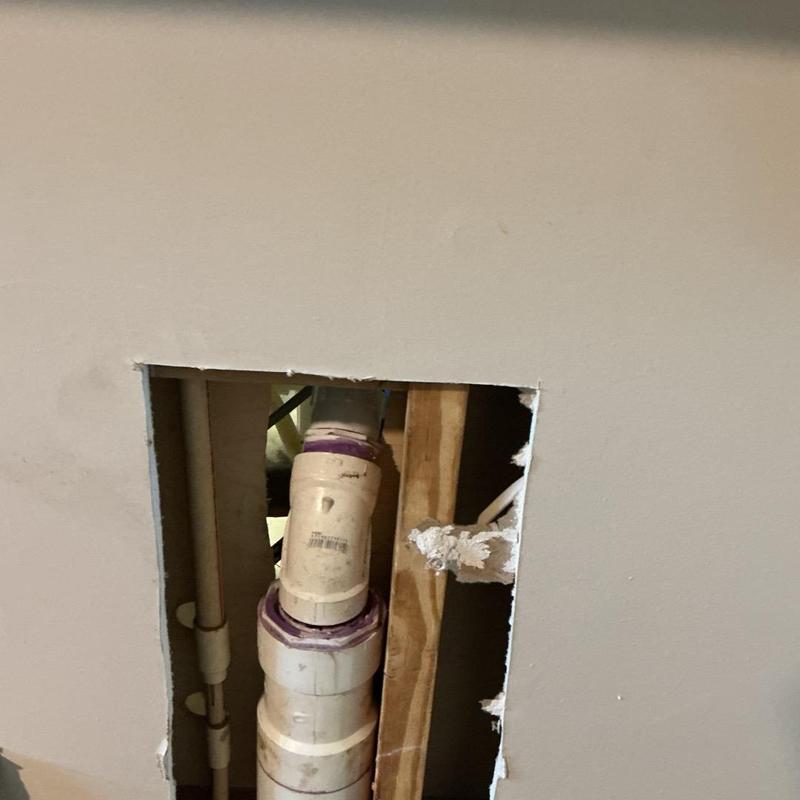 Kitchen drain pipe lowered behind drywall cutout Kitchen drain pipe lowered behind drywall cutout