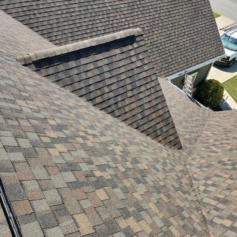 Laminated architectural shingle roof with ridge vent