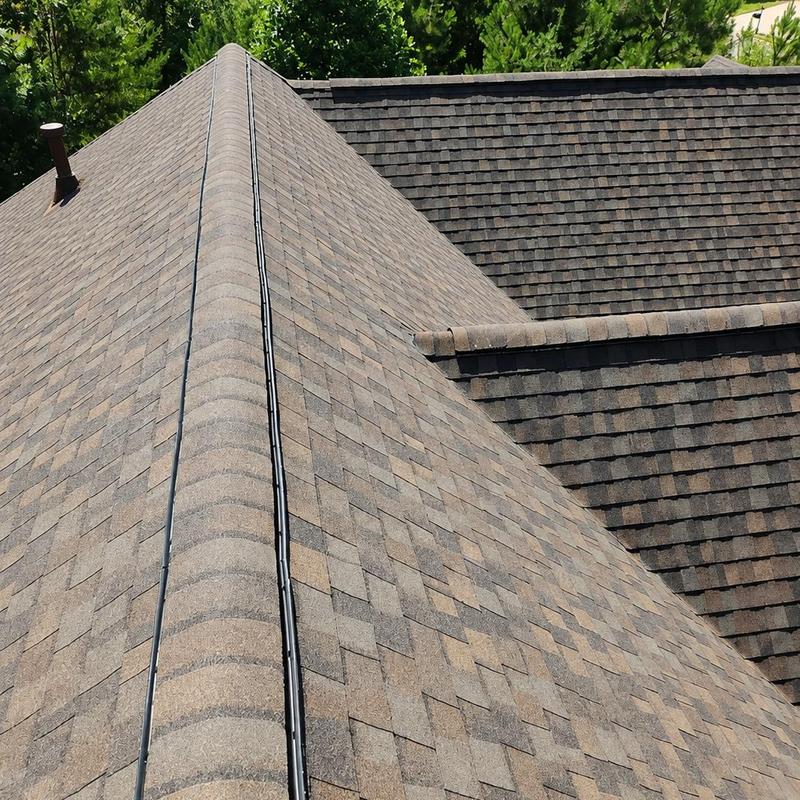 Laminated architectural shingle roof with ridge vent