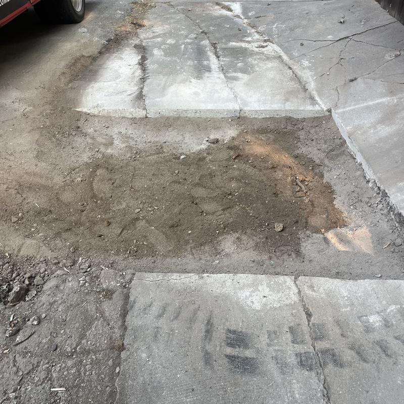 Clay sewer main excavation patch in driveway trench Clay sewer main excavation patch in driveway trench